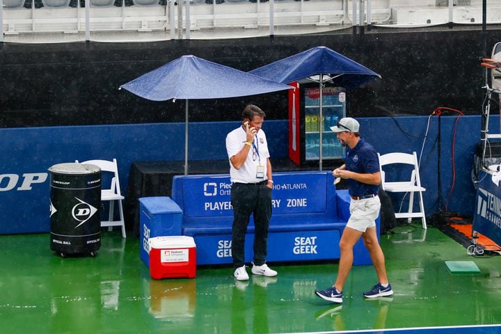 Atlanta Open Director Peter Lebedevs is spotted on the phone as rain delays the opening exhibition match at the Atlanta Open tennis tournament on Sunday, July 21, 2024.
(Miguel Martinez / AJC)