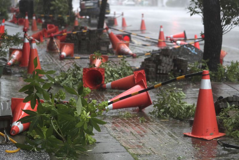 Traffic cones litter the pavement as Typhoon Krathon arrives in Kaohsiung, southern Taiwan, Thursday, Oct. 3, 2024. (AP Photo/Chiang Ying-ying)