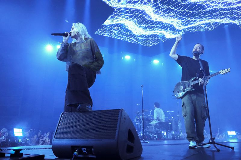 Emily Armstrong, from left, Colin Brittain, and Mike Shinoda of Linkin Park performs Thursday, Sept. 5, 2024, in Los Angeles. It was announced on Thursday that Dead Sara's Emily Armstrong would join as the band's new co-singer and songwriter/producer Colin Brittain would join on drums. Linkin Park will release the album "From Zero" on Nov. 15, marking their first new record since former frontman Chester Bennington died in 2017. (Photo by Jordan Strauss/Invision/AP