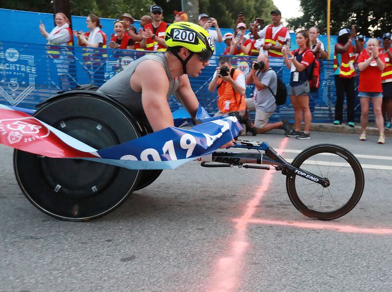Daniel Romanchuk wins the men's wheelchair race in record time and a $50,000 bonus during the 50th AJC Peachtree Road Race on Thursday, July 4, 2019, in Atlanta.  Curtis Compton/ccompton@ajc.com