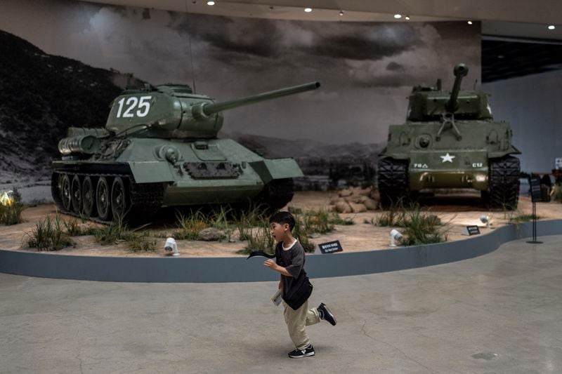 A boy runs across an exhibition hall displaying Sherman tanks, the main battle tanks used during the Korean War, at the War Memorial of Korea in Seoul, Wednesday, May 29, 2024. (AP Photo/Jae C. Hong)