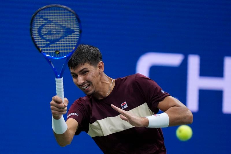 Alexei Popyrin, of Australia, returns a shot to Novak Djokovic, of Serbia, during a third round match of the U.S. Open tennis championships, Friday, Aug. 30, 2024, in New York. (AP Photo/Julia Nikhinson)