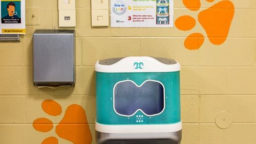 "Iggy", 30e Scientific's first aqueous ozone hand washing station is installed in the Bryant Elementary School cafeteria in Mableton. The sanitation station uses ozone, a natural disinfectant, to clean elementary school hands in seven seconds before students pick up their school lunches.  The Cobb County School District and the makers of the three sanitation systems installed at the school share information before moving into demonstrates of the technologies Wednesday, Oct 21, 2020.  (Jenni Girtman for The Atlanta Journal-Constitution)