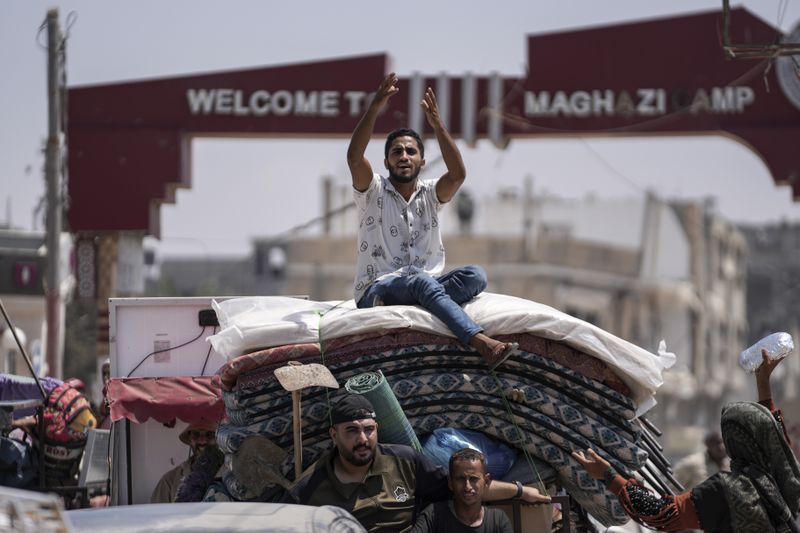 Palestinians evacuate Maghazi refugee camp in the central Gaza Strip, as part of a mass evacuation ordered by the Israeli military ahead of an operation, Saturday, Aug. 17, 2024. (AP Photo/Abdel Kareem Hana)