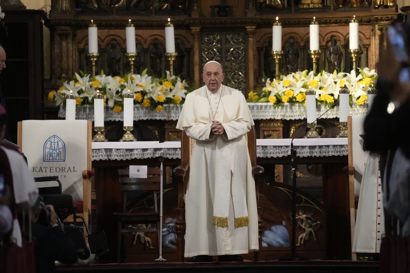 Pope Francis attends a meeting with Catholic priests, nuns and seminarians inside the Cathedral of Our Lady of the Assumption in Jakarta, Wednesday, Sept. 4, 2024. Pope Francis urged Indonesia to live up to its promise of "harmony in diversity" and fight religious intolerance on Wednesday, as he set a rigorous pace for an 11-day, four-nation trip through tropical Southeast Asia and Oceania that will test his stamina and health. (AP Photo/Gregorio Borgia)