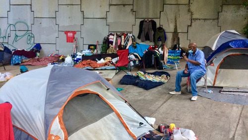 J.R. Simpson is living in a tent under a bridge right off the Downtown Connector. "Everybody here is all right," he said. "They all have to get along." Photo by Bill Torpy