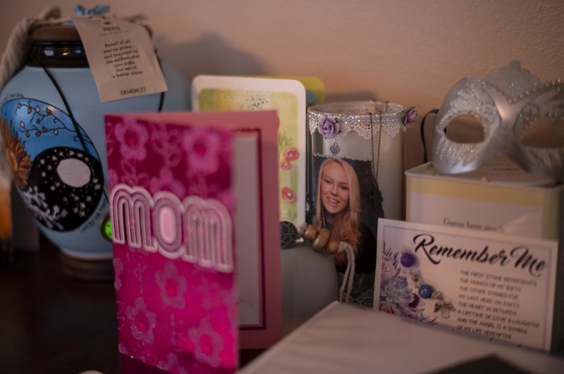 A photo of Alexandra Capelouto, who died from a fentanyl overdose, sits next to an urn holding her ashes in Temecula, Calif., Tuesday, Sept. 17, 2024. (AP Photo/Jae C. Hong)