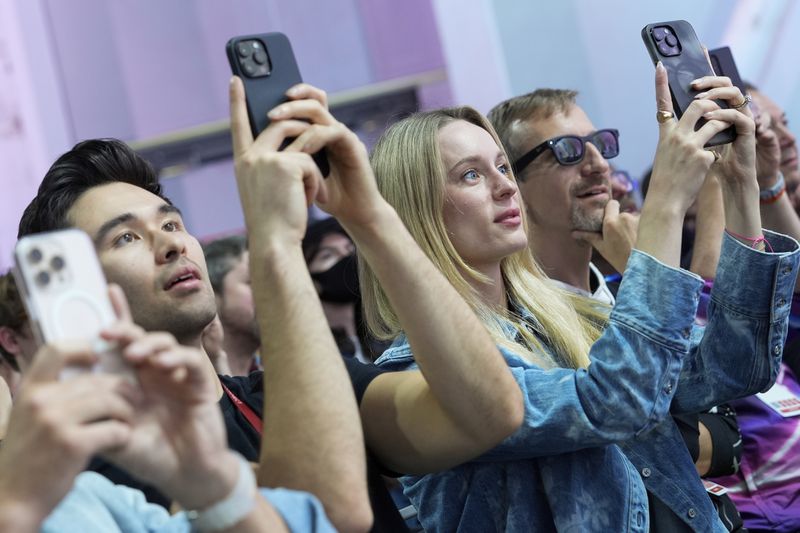 People use their cell phones as they watch a presentation at the Meta Connect conference Wednesday, Sept. 25, 2024, in Menlo Park, Calif. (AP Photo/Godofredo A. Vásquez)