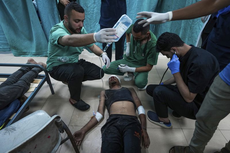 A Palestinian wounded in the Israeli bombardment of the Gaza Strip is treated in a hospital in Deir al Balah on Tuesday, June 18, 2024. (AP Photo/Abdel Kareem Hana)