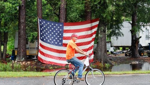 George Smith, 67, of Homerville, arrives at his trailer after riding his bicycle Tuesday morning. “Luckily, nothing big happened around here; just a few trees down," he said.