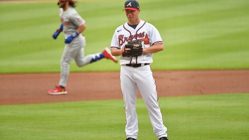 Braves pitcher Robbie Erlin (49) reacts after he allowed a two-run home run by Philadelphia Phillies right fielder Bryce Harper (background) during the first inning at Truist Park on Saturday, August 22, 2020. (Hyosub Shin / Hyosub.Shin@ajc.com)