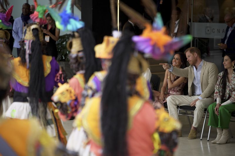 Prince Harry and Meghan attend a welcoming ceremony, at the Delia Zapata National Arts Center, accompanied by director Xiomara Suescun, right, in Bogota, Colombia, Thursday, Aug. 15, 2024. (AP Photo/Ivan Valencia)