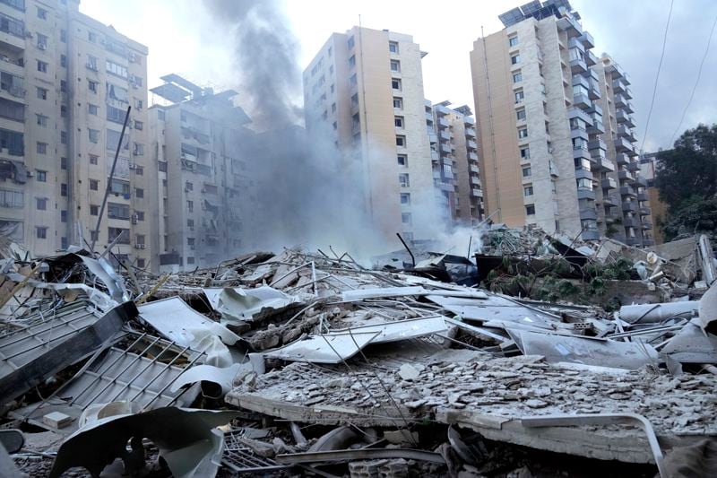 Smoke rises from a destroyed resident complex hit by Israeli airstrikes in Dahieh, Beirut, Lebanon, Wednesday, Oct. 2, 2024. (AP Photo/Hussein Malla)