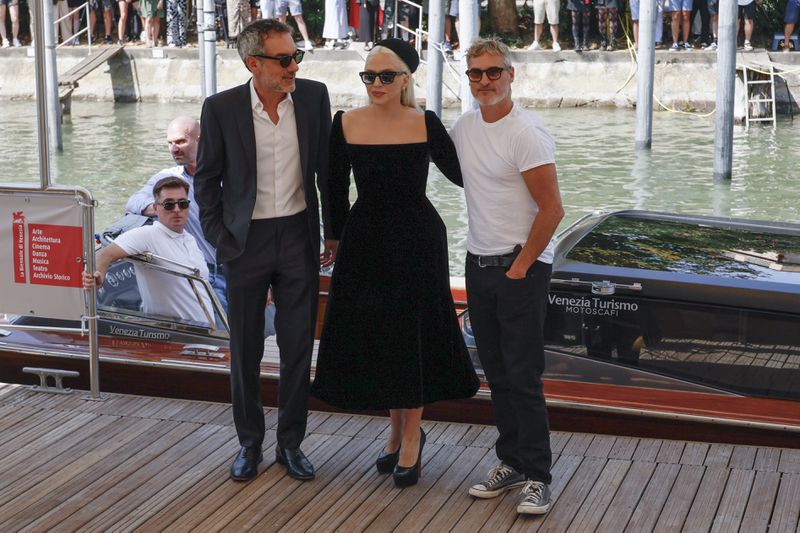 Director Todd Phillips, from left, Lady Gaga and Joaquin Phoenix pose for photographers upon arrival for the press conference of the film 'Joker: Folie A Deux' during the 81st edition of the Venice Film Festival in Venice, Italy, on Wednesday, Sept. 4, 2024. (Photo by Joel C Ryan/Invision/AP)