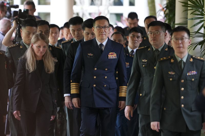China's Defense Minister Dong Jun, center, walks out after a bilateral meeting with U.S. Secretary of Defence Lloyd Austin on the sidelines of the 21st Shangri-La Dialogue summit at the Shangri-La Hotel in Singapore Friday, May 31, 2024. (AP Photo/Vincent Thian)