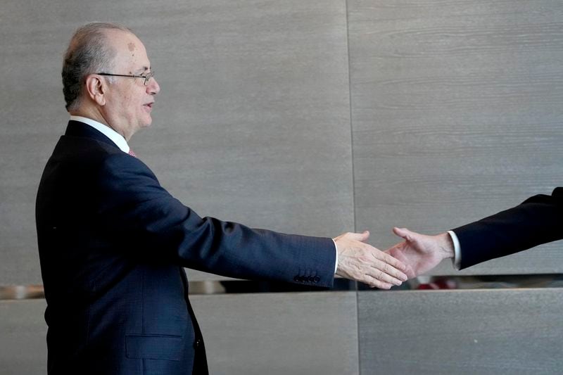 Prime Minister of the Palestinian Authority Mohammed Mustafa, left, reaches out to shake hands with Norway's Foreign Minister Espen Barth Eide prior to a meeting for talks on the Middle East in Brussels, Sunday, May 26, 2024. Norway on Sunday handed over papers to the Palestinian prime minister to officially give it diplomatic recognition as a state in a largely symbolic move that has infuriated Israel. (AP Photo/Virginia Mayo)
