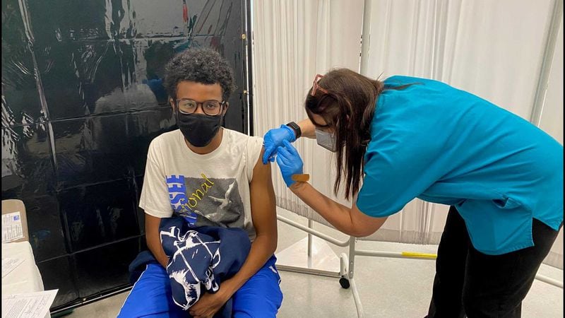 Georgia Tech nurse Melanie Thomas administers a COVID-19 vaccine shot to student Grayson Prince earlier this month at the school's Exhibition Hall. Georgia's rate for full vaccination currently hovers around 40%. ERIC STIRGUS/ESTIRGUS@AJC.COM.