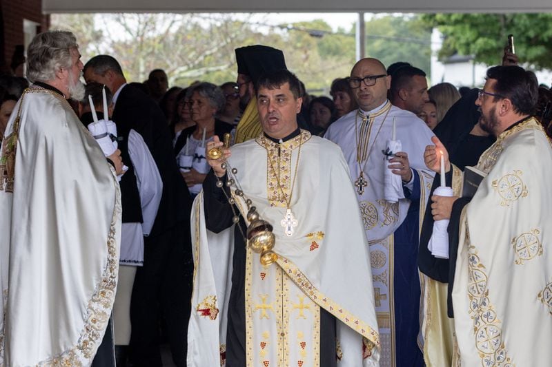 Clergymen chant during a funeral service for Ana Cristina Irimie, a math teacher killed at Apalachee High School during a school shooting, at Hamilton Mill Memorial Chapel and Gardens in Buford on Saturday, September 14, 2024. (Arvin Temkar / AJC)