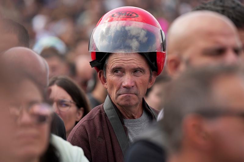 A man attends the IX Pilgrimage of the Blessing of Helmets that draws tens of thousands at the Roman Catholic holy shrine of Fatima, in Fatima, Portugal, Sunday, Sept. 22, 2024. (AP Photo/Ana Brigida)