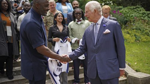 King Charles III meets Idris Elba, left, and young people attend an event for The King's Trust to discuss youth opportunity, at St James's Palace in central London, Friday July 12, 2024. The King and Mr Elba, an alumnus of The King's Trust (formerly known as The Prince's Trust), are meeting about the charity's ongoing work to support young people, and creating positive opportunities and initiatives which might help address youth violence in the UK, as well as the collaboration in Sierra Leone between the Prince's Trust International and the Elba Hope Foundation. (Yui Mok/pool photo via AP)