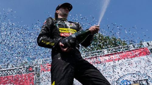 Colton Herta, of the United States, celebrates with his team after winning an IndyCar auto race in Toronto, Sunday, July 21, 2024. (Frank Gunn/The Canadian Press via AP)