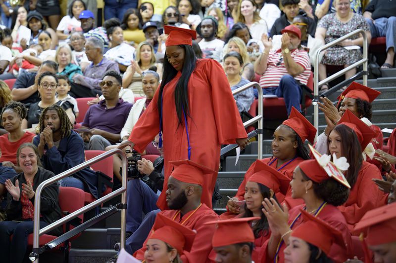 Sparkle Graham is recognized for her achievement during a high school equivalency (HiSET) diploma graduation ceremony for the Youth Empowerment Project (YEP) in New Orleans, Thursday, June 27, 2024. (AP Photo/Matthew Hinton)