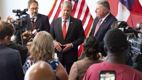 Gov. Brian Kemp, flanked by Department of Community Health Commissioner Russel Carlson, left, and Insurance Commissioner John King during a press conference to discuss the first rollout milestones of the 2019 Patients First Act in Atlanta on Monday, Aug. 19, 2024.   (Ben Gray / Ben@BenGray.com)