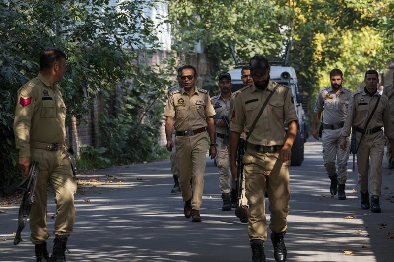 Indian policemen patrol as they guard near a venue for distribution of election material, ahead of the second phase of voting for choosing a local government in Indian-controlled Kashmir, in Srinagar, Tuesday, Sept. 24 , 2024. (AP Photo/Mukhtar Khan)