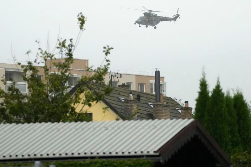 An army helicopter flies over the flooded Jesenik, Czech Republic, Sunday, Sept. 15, 2024. (AP Photo/Petr David Josek)