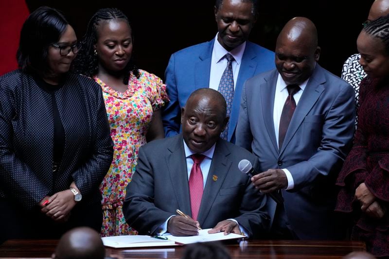 FILE — South African President Cyril Ramaphosa signs a bill for National Health Insurance signed into law in Pretoria, South Africa, Wednesday, May 15, 2024. Several polls have the African National Congress' support below 50% ahead of next Wednesday's, May 29, 2024 vote, raising the prospect that it might not be the majority party for the first time since Nelson Mandela led it to victory in the first all-race elections that ended white minority rule in 1994. (AP Photo/Themba Hadebe, File)
