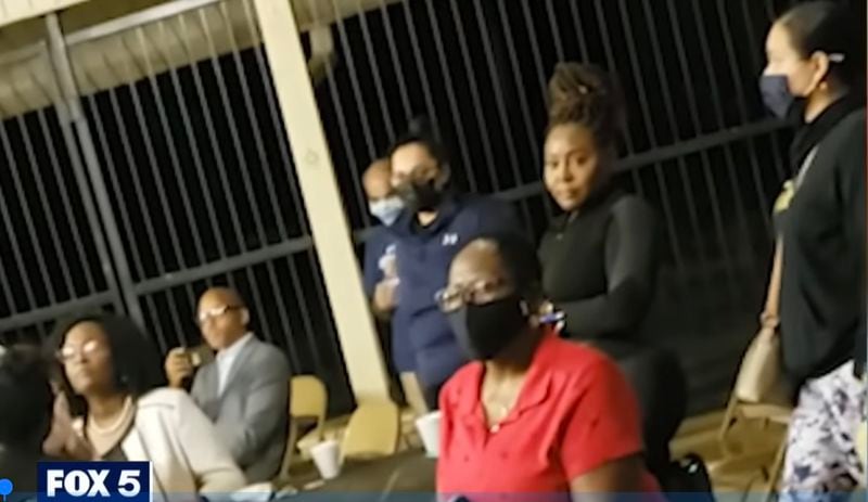 Douglas County Probate Judge Christina Peterson (behind the woman in red) argues with neighbors at a homeowner association meeting. Photo courtesy of Fox 5.
