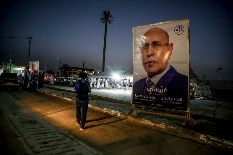 An electoral banner for Mauritanian president Mohamed Ould Ghazouani is placed during a campaign rally, ahead of the presidential elections in Nouakchott, Mauritania, Wednesday, June 26, 2024. Banner in Arabic reads: "Safe choice." (AP Photo/Mamsy Elkeihel)