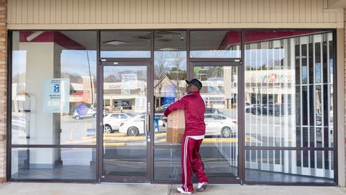 Anthony Walker leaves the U.S. Post Office at Perimeter Village in Atlanta on Dec. 27. (Arvin Temkar/AJC 2023)