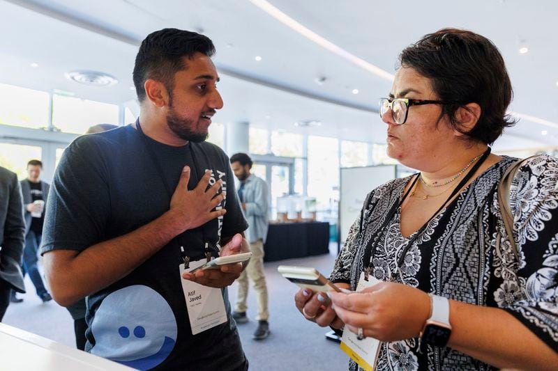 Tarjimly co-founder Atif Javed talks to attendee Lauren Welke about Tarjimly at the Google Impact Summit on Wednesday, Sept. 4, 2024, in Sunnyvale, Calif. (AP Photo/Juliana Yamada)