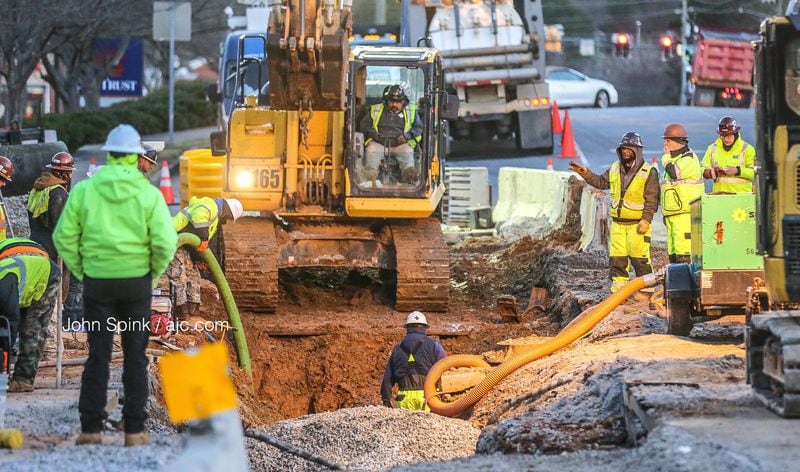A 30-inch water main broke at Fairburn Road near Cascade Road on Monday. JOHN SPINK / JSPINK@AJC.COM
