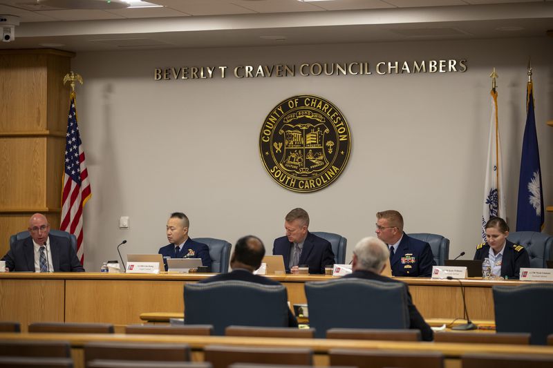 Members of the Coast Guard's Titan Submersible Marine Board of Investigation listen during the formal hearing inside the Charleston County Council Chambers, Monday, Sept. 23, 2024, in North Charleston, S.C. (Laura Bilson/The Post And Courier via AP, Pool)