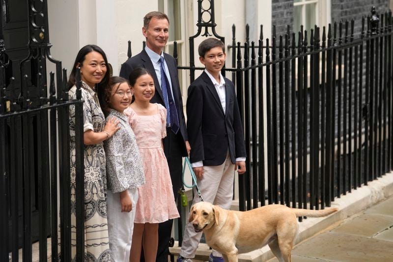 Outgoing Conservative chancellor of the exchequer Jeremy Hunt, with his wife Lucia Hunt and their children Jack, Anna and Eleanor leave 11 Downing Street after the Labour party won a landslide victory in the general election, Friday, July 5, 2024. Britain's Labour Party swept to power Friday after more than a decade in opposition, as a jaded electorate handed the party a landslide victory — but also a mammoth task of reinvigorating a stagnant economy and dispirited nation. (AP Photo/Vadim Ghirda)