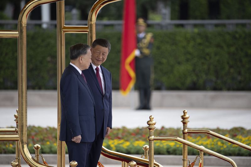 Chinese President Xi Jinping, right, and Vietnam's President To Lam attend a welcome ceremony at the Great Hall of the People in Beijing Monday, Aug. 19, 2024. (Andres Martinez Casares/Pool Photo via AP)