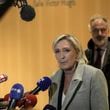 French far-right leader Marine Le Pen, front, speaks to the media as she arrives at the court house in Paris, Monday, Sept. 30, 2024. (AP Photo/Thibault Camus)