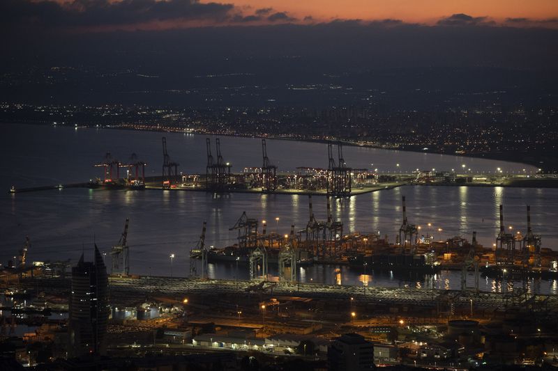 Gantry cranes used to load and unload cargo containers from ships sit stand during the dawn, in the port of Haifa, Israel, Thursday, Aug. 15, 2024. (AP Photo/Leo Correa)