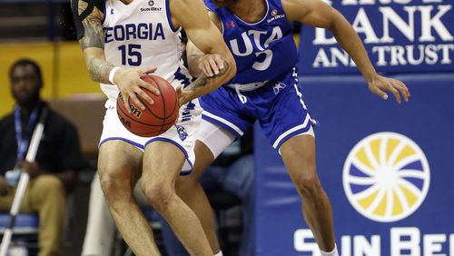 Georgia State guard D'Marcus Simonds (23) is defended by Texas-Arlington guard Edric Dennis (5) during the first half of the NCAA college basketball championship game of the Sun Belt Conference men's tournament in in New Orleans, Sunday, March 17, 2019. (AP Photo/Tyler Kaufman)