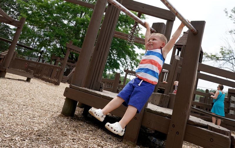 Lorne Hart, 3, of Darlington, Pennsylvania, plays in Rainbow Dreamland, part of the East Palestine City Park, Saturday, July 15, 2023, in East Palestine, Ohio. Norfolk Southern has pledged to make significant upgrades to the park. (Matt Freed for The Atlanta Journal-Constitution)