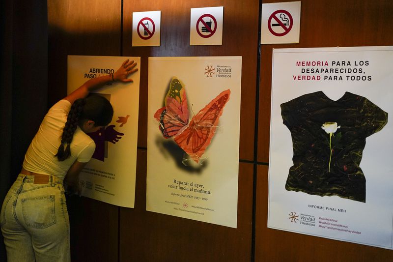 Posters about missing people are placed on a wall for the presentation of a report about the country’s 1965-1990 “dirty war” by Mexico's governmental Truth Commission in Mexico City, Friday, Aug. 16, 2024. The poster at right reads in Spanish "Remembrance for the disappeared. The truth for all." (AP Photo/Eduardo Verdugo)