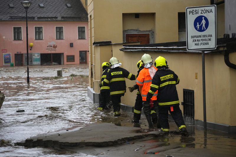 Firemen attend to a house during floods in Jesenik, Czech Republic, Sunday, Sept. 15, 2024. (AP Photo/Petr David Josek)