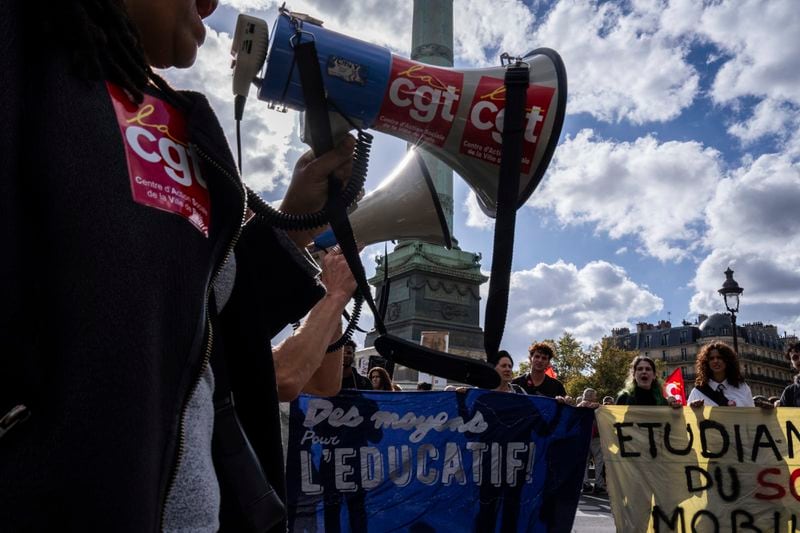 Protesters march during a rally against the new government of French Prime Minister Michel Barnier, in Paris, Tuesday, Oct. 1, 2024. (AP Photo/Louise Delmotte)