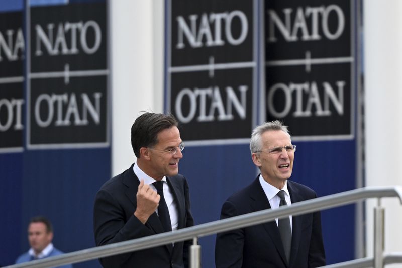 NATO Secretary General Jens Stoltenberg, right, with incoming NATO Secretary General Mark Rutte arrives for a transition ceremony at NATO headquarters in Brussels, Tuesday, Oct. 1, 2024. (AP Photo/Harry Nakos)