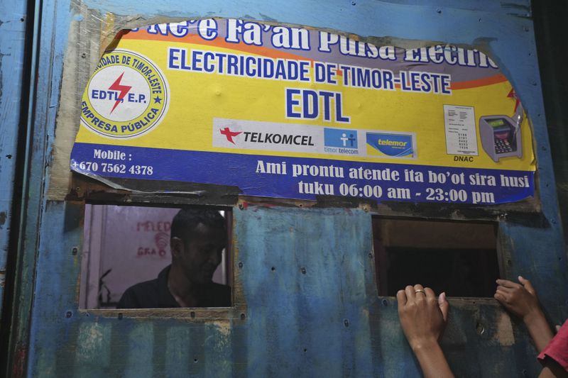 A man sells electricity credit at a shop in Dili, East Timor Sunday, Sept. 8, 2024. (AP Photo/Firdia Lisnawati)