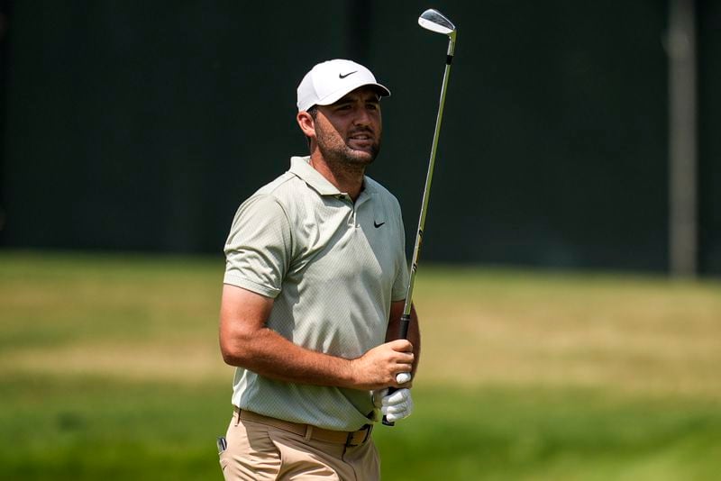 Scottie Scheffler watches his ball on the first fairway during the final round of the Tour Championship golf tournament, Sunday, Sept. 1, 2024, in Atlanta. (AP Photo/Mike Stewart)