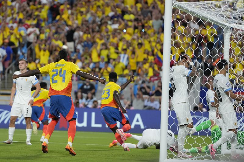 Uruguay's Mathias Olivera holds his head after Colombia's Jefferson Lerma scored his side's first goal during a Copa America semifinal soccer match in Charlotte, N.C., Wednesday, July 10, 2024. (AP Photo/Julia Nikhinson)