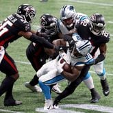 Atlanta Falcons safety Keanu Neal (22) and teammates tackle Carolina Panthers running back Mike Davis (28) in the first quarter on Sunday, Oct. 11, 2020 at Mercedes-Benz Stadium in Atlanta, Georgia. (Jason Getz/Atlanta Journal-Constitution/TNS)